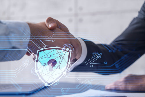 Two business professionals shaking hands in front of a digital shield graphic representing cyber incident response technology.