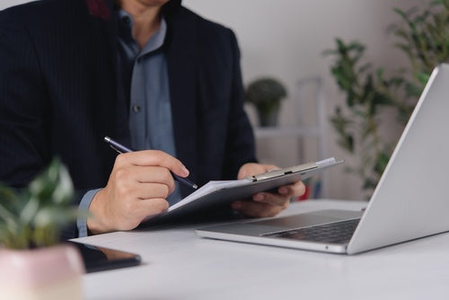 INQ digital pen and notebook beside a laptop showing Filevine's LOIS platform, illustrating the new AI-powered handwriting integration.