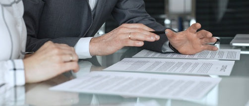 In-house lawyer reviewing outside counsel rate proposals.